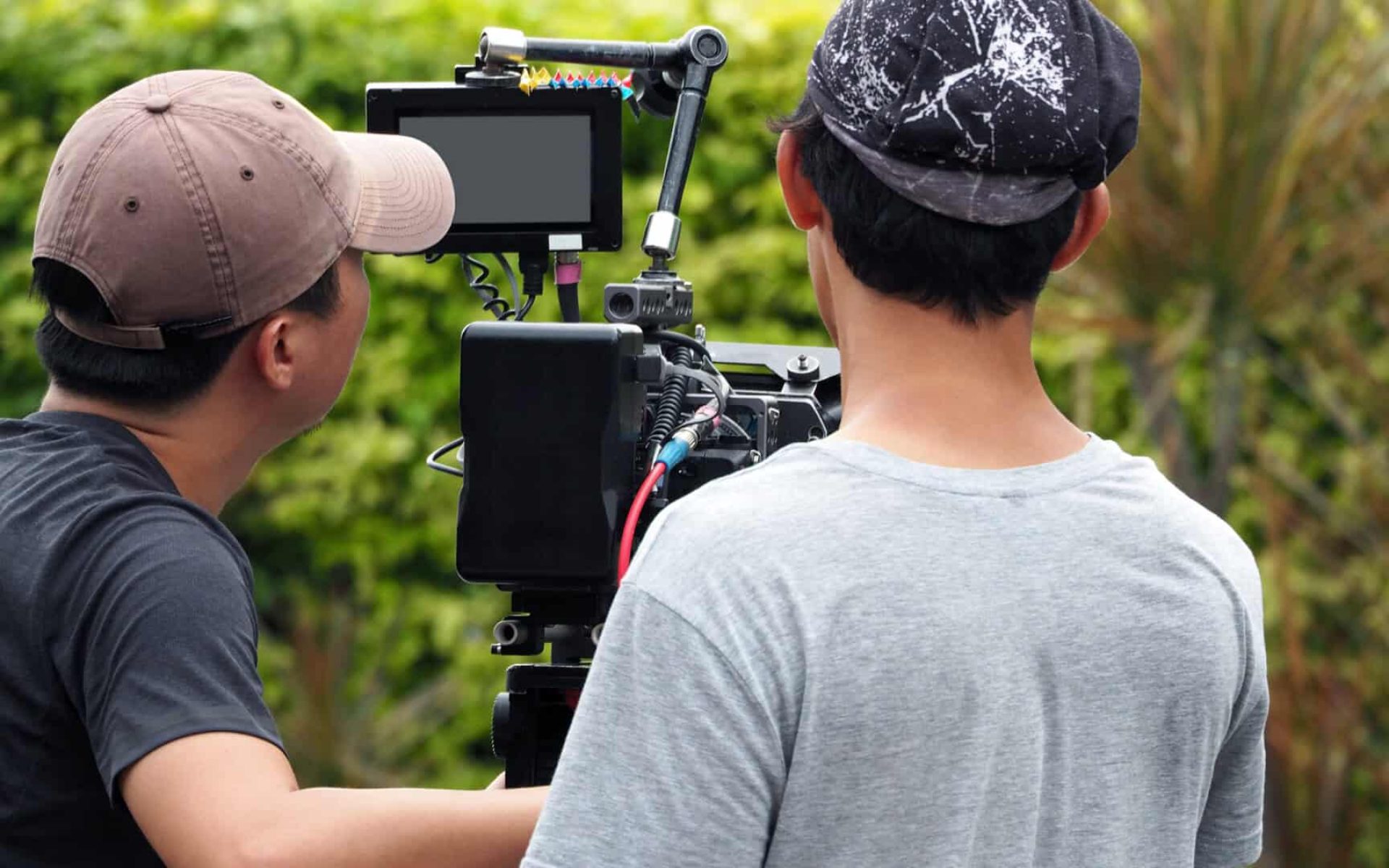 Behind the scenes of vdo production or video shooting at outdoor location with film crew camera team and movie director.