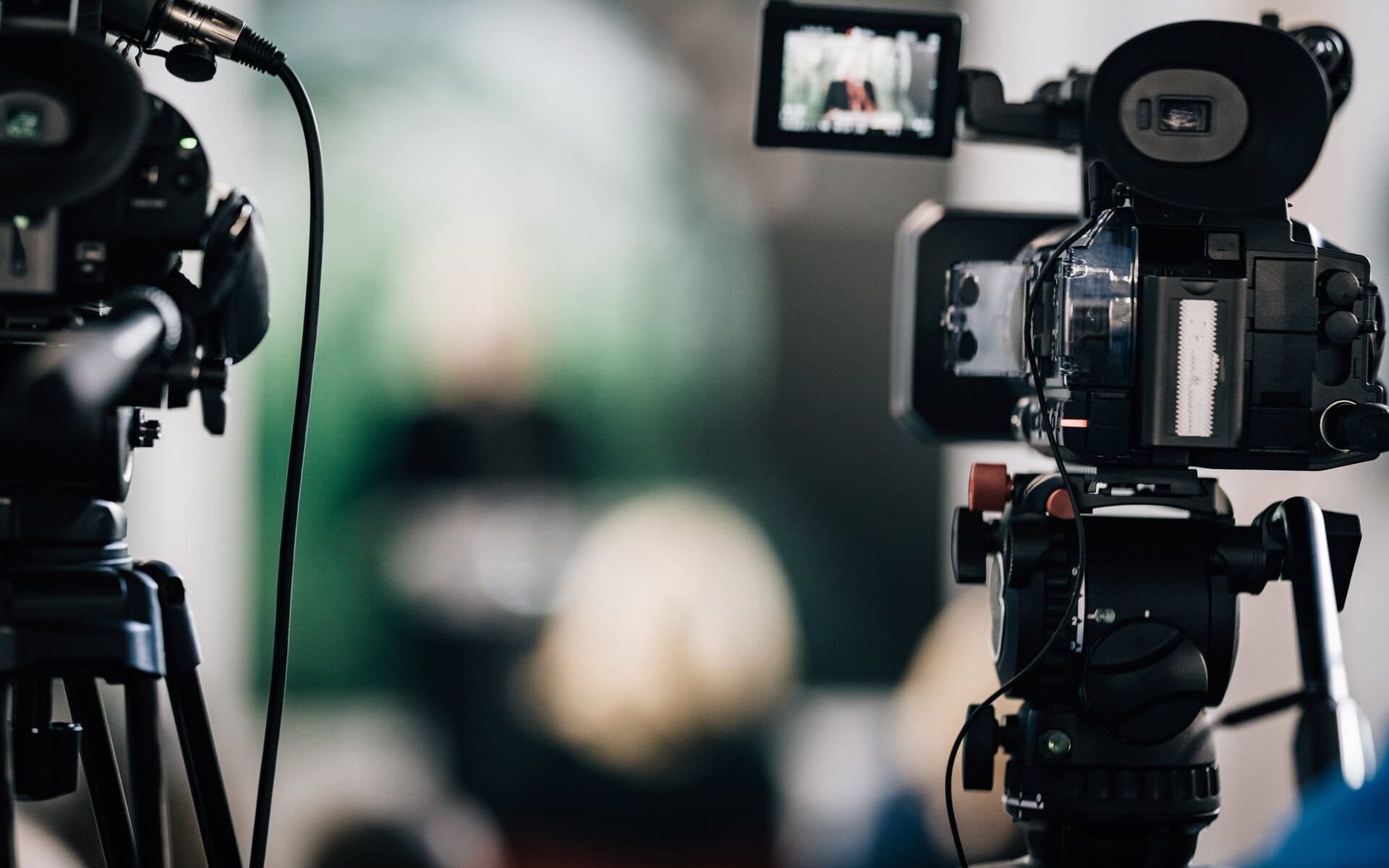 Cameras at a live media conference.