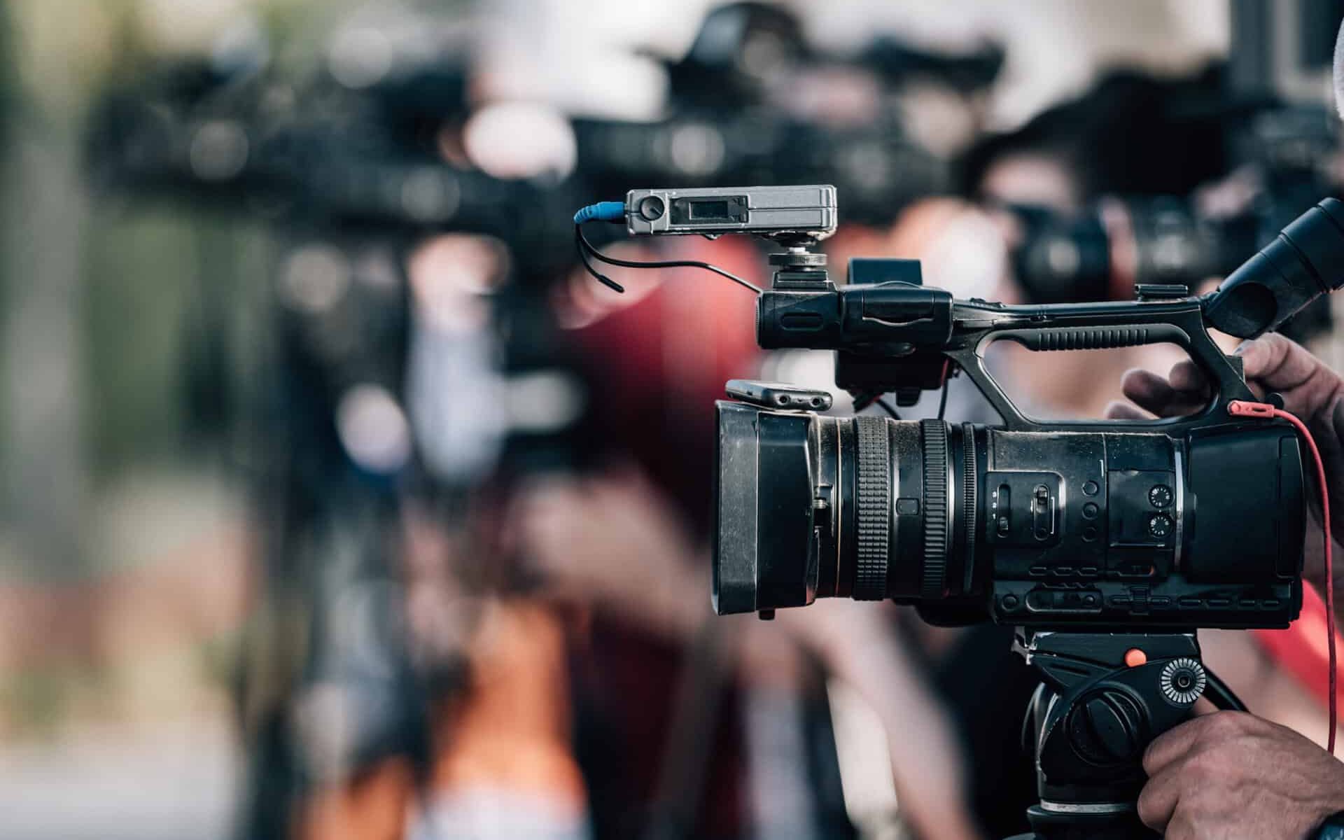 Group of Cameras at an Outdoor Press Conference